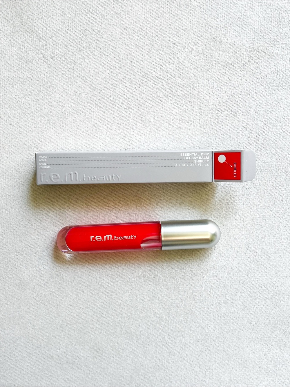 r.e.m. beauty Essential Drip Glossy Balm — Red Shirley